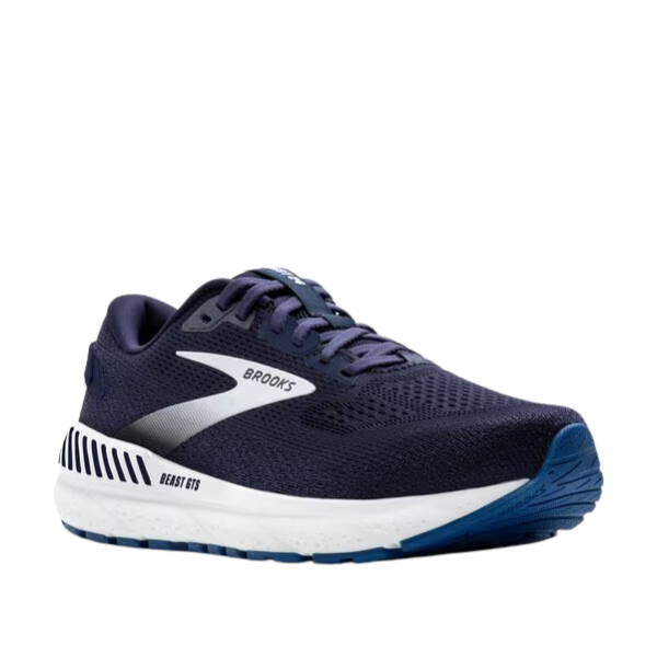 The BROOKS Mens Beast GTS 24 Wide Navy is a navy running shoe with a white sole, blue rubber outsole, silver accents, breathable mesh, Brooks branding, Beast GTS text on the side, and offers maximum support.