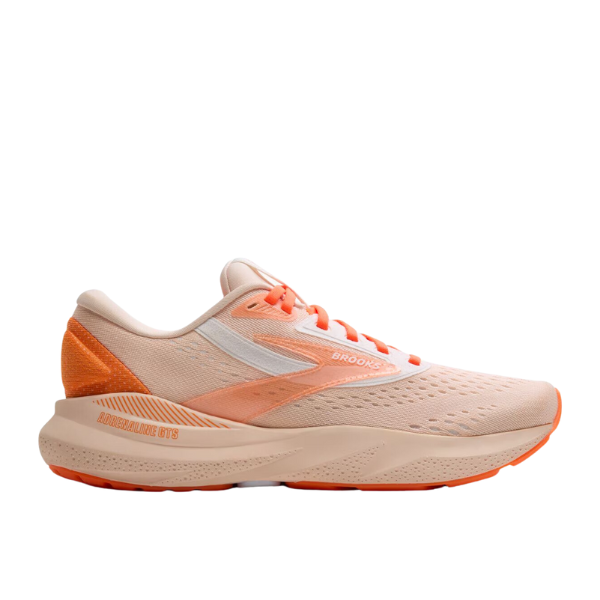 The Brooks Womens Adrenaline GTS 24 Pink running shoe features a light peach and orange mesh upper, white side stripe, cushioned sole, GuideRails® support, and orange accents on the heel and outsole.