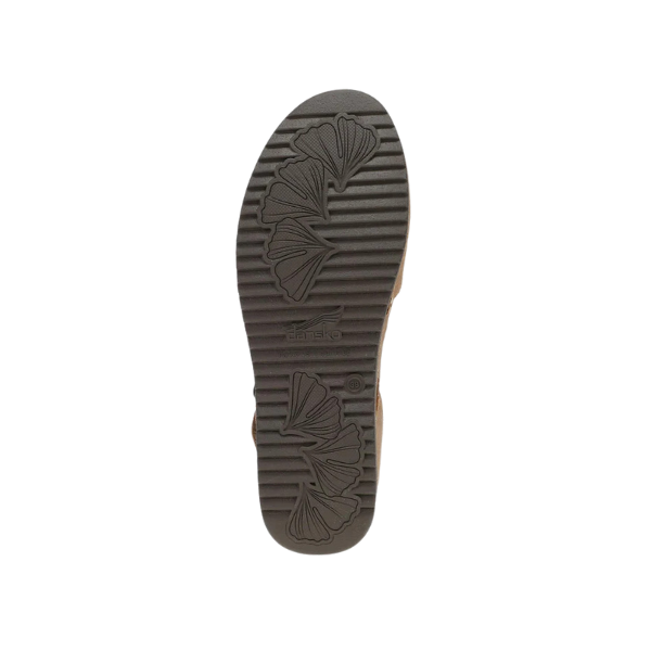 The lightweight EVA and cork sole of the Dansko Womens Mae Tan Suede shoe features a ridged pattern with leaf-like designs and the DANSKO logo at the center, shown against a white background.
