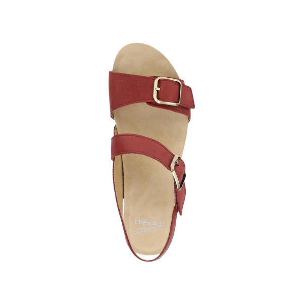 The DANSKO Womens Trinity Cayenne Burnished sandal features two adjustable buckle straps and a tan footbed with arch support, offering comfort and plantar fasciitis relief. Shown from above on a white background.