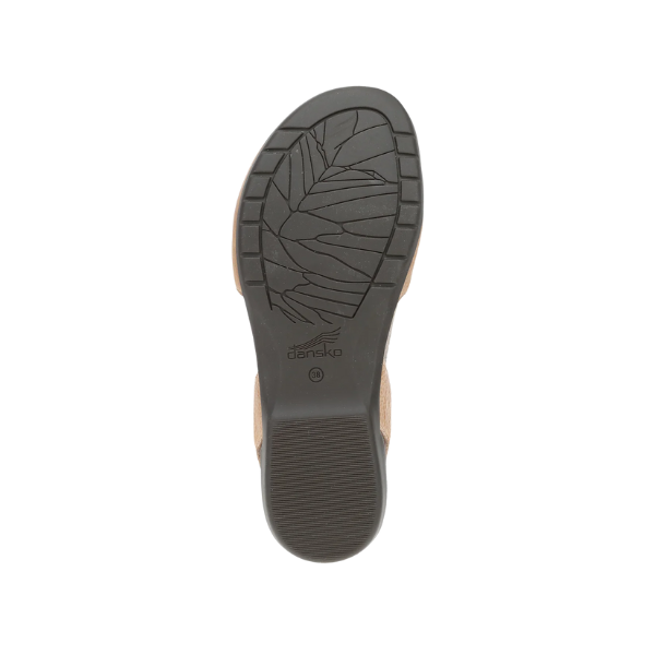 The image displays the sole of the Dansko Womens Rowan Honey Distressed sandal by DANSKO, featuring a leaf-patterned tread and central Dansko logo, photographed against a white background.