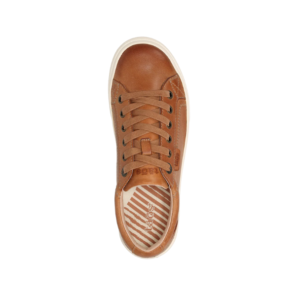 TAOS Womens Plim Soul Lux Caramel sneaker in brown leather with a white sole, shown from above. The insole displays tan and white stripes, the taos logo, and the signature Curves & Pods® footbed for comfort.