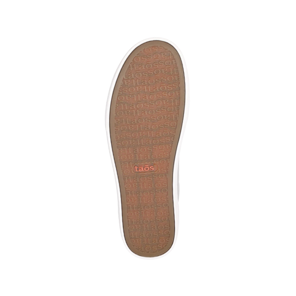 The image displays the sole of the Taos Womens Plim Soul Lux Silver shoe, featuring a tan rubber bottom designed for metatarsal support. The sole is embossed with taos and has a single red TAOS logo near the center.