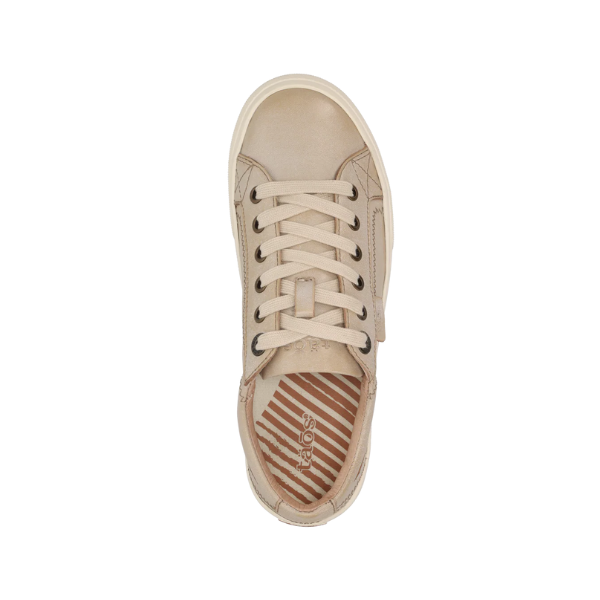 Top view of the Taos Womens Plim Soul Lux Oyster sneaker, featuring a beige upper, rubber toe cap, patterned insole with diagonal stripes, TAOS branding, and Curves & Pods footbed with metatarsal support.