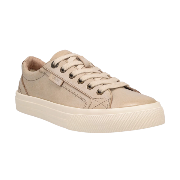 The TAOS Womens Plim Soul Lux Oyster is a beige low-top sneaker with matching laces, textured sole, side stitching, and a Curves & Pods footbed for added comfort.