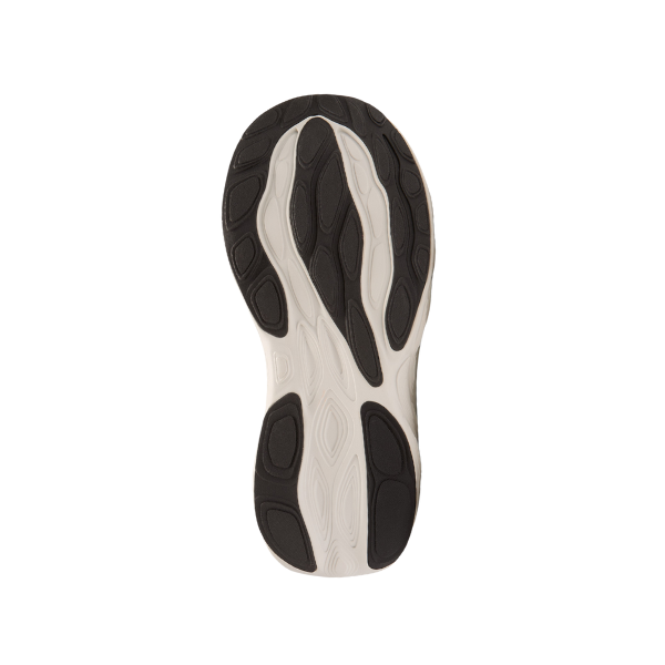The image shows the sole of the NEW BALANCE Womens Fresh Foam X 1080v14 Wide White/Green running shoe, featuring a wavy light beige design with black textured rubber for grip and visible Fresh Foam X cushioning on a white background.