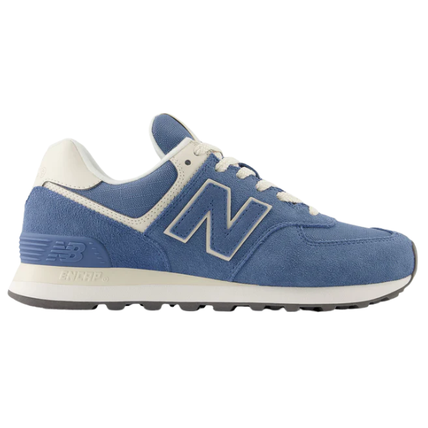 The New Balance Women's 574 Blue sneaker features a blue and white suede and mesh upper, white laces, a rubber sole, and the iconic N logo for a classic retro style from NEW BALANCE.