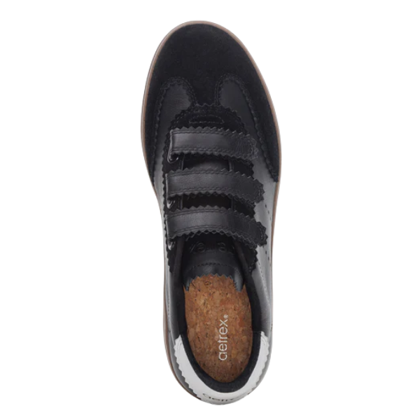 Top view of the Aetrex Women's Morgan Black sneaker by AETREX WORLDWide INC featuring black leather, three Velcro straps, and a visible brown cork insole—ideal for those seeking arch support shoes.