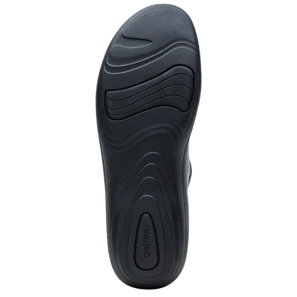 Black shoe sole with 'Aetrex' branding on a white background