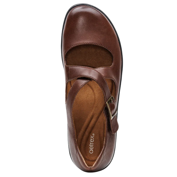 Brown leather shoe with a strap on a white background