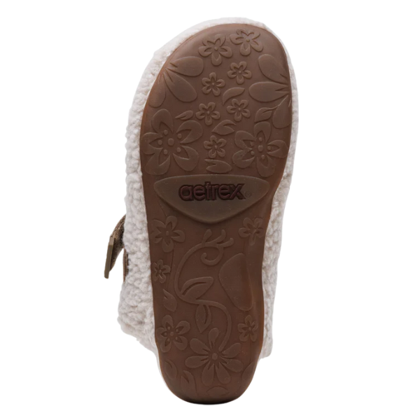 Close-up of a sandal sole with floral patterns and 'Aetrex' branding on a white background