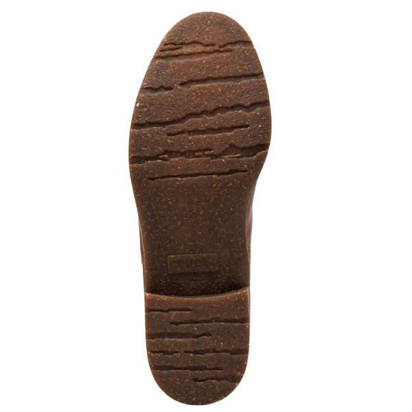 The image shows the sole of the Aetrex Women's Kaylee Cognac boot by AETREX WORLDWide INC, featuring a brown, cork-like material with a wavy tread and a rectangular label near the heel for arch support.