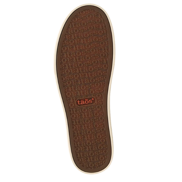 The sole of the Taos Women's Winner Caramel sneaker, by TAOS, is brown with a beige edge and has "taös" repeatedly embossed. Near the heel, a red rectangle with "taös" in white stands out.