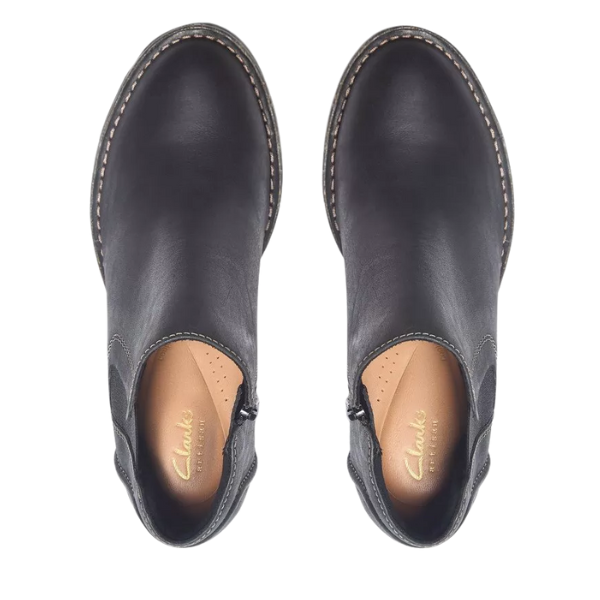 Top view of Clarks Women's Kastela Lo Black Leather ankle boots with beige insoles and gold "CLARKS" branding—stylish, comfortable block heel boots for women.