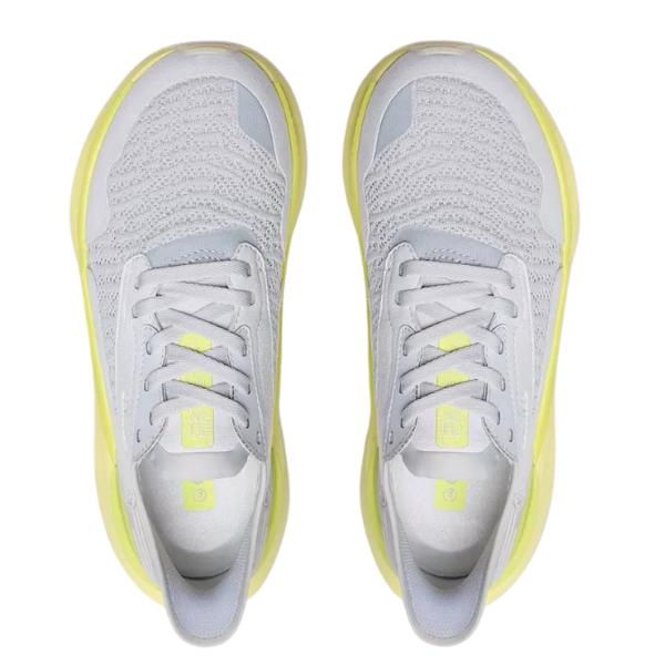 A pair of CLARKS Women's Pace Lime sneakers in gray with light yellow soles and accents, knit texture, laces, and logo on the tongue, shown from above on a white background.