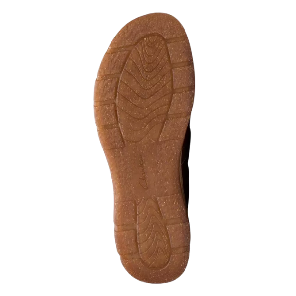 The image shows the sole of a Clark's Women's Orlene Clog in Tan Combination Nubuck, a casual shoe with textured tread and curved grooves for grip. The CLARKS logo is embossed near the center of the sole against a white background.