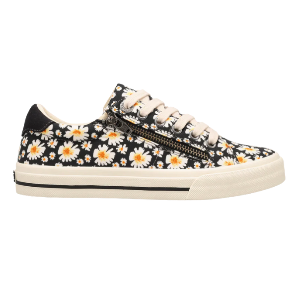 The TAOS Taos Women's Z Soul Daisy Black sneaker is a low-top canvas shoe with white and yellow daisy print, white laces, a side zipper, white rubber sole with black stripe, and built-in arch support for comfort.