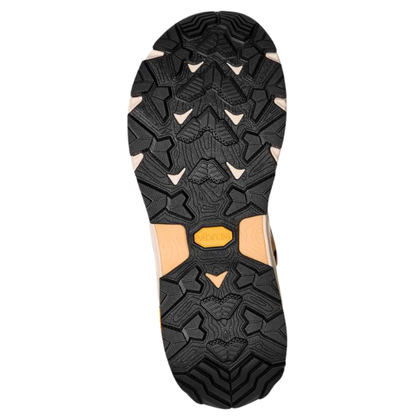 Close-up of the durable black sole from TEVA Women's Grandview Max GORE-TEX Honey hiking boots, showcasing geometric treads, tan accents, and a yellow Vibram logo—emphasizing their waterproof performance.