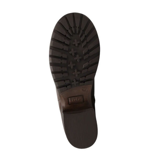 The image shows the sole of the TAOS Women's Uptown Dark Brown ankle boot, featuring a rugged tread with deep grooves and cross-shaped lugs for traction, plus a stacked heel for added stability.