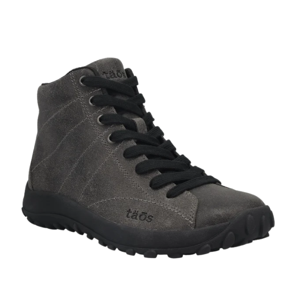 The Taos Women's Trail Mix Charcoal is a gray suede high-top sneaker with black laces, a rugged black rubber sole, TAOS branding on the side, and a supportive footbed for all-day comfort.