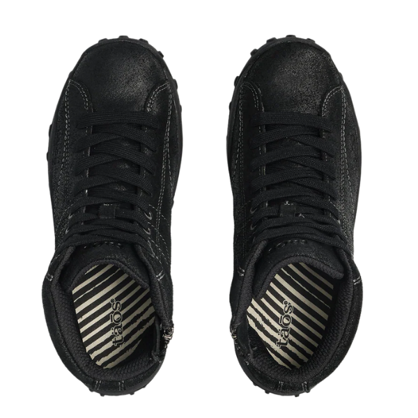 The TAOS Women's Trail Mix Black shoes feature a black lace-up design, striped black and white insoles with the taos logo by the heel, and a supportive footbed for enhanced comfort.