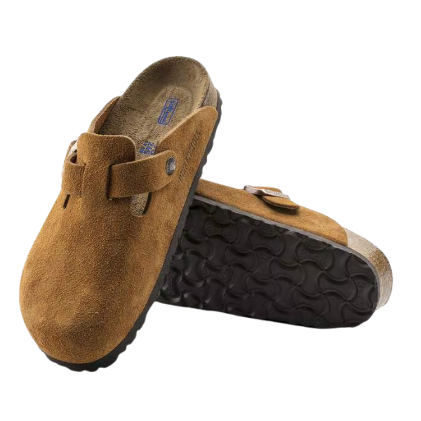 A pair of Birkenstock Men's Boston Soft Footbed Mink clogs by BIRKENSTOCK, featuring brown suede uppers and black textured rubber soles. One clog stands upright; the other lies on its side, showing the patterned sole.