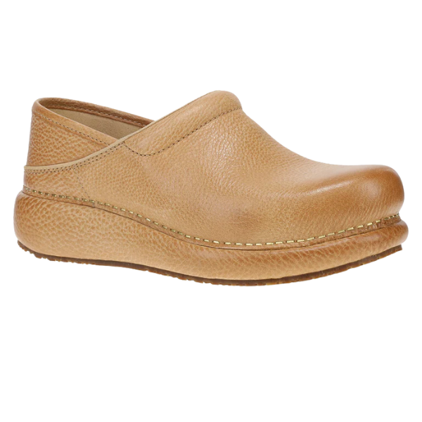 The Dansko Women's Honey Pro Cloud clog features a tan leather upper, rounded toe, low heel, textured sole, visible side stitching, memory foam footbed for comfort, and an easy slip-on design.