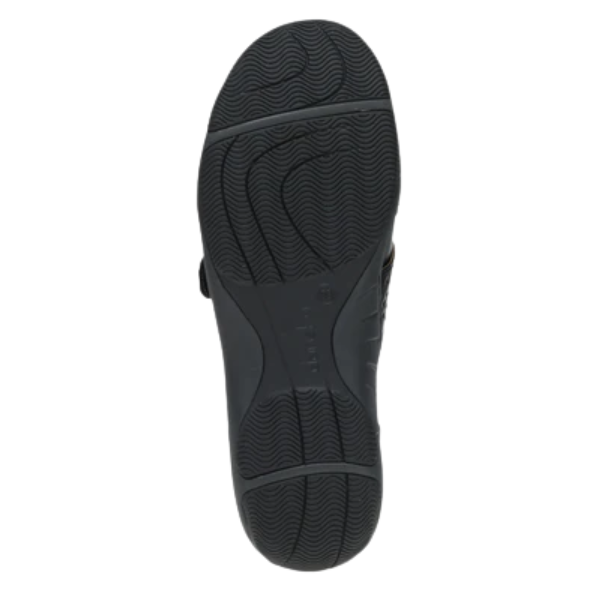 The image shows the black rubber sole of Dankso Women's Stacy Black by DANSKO, featuring a textured, wavy pattern for slip resistance. The brand name is embossed in the center. Set against a white background, it’s ideal for women seeking comfortable shoes.