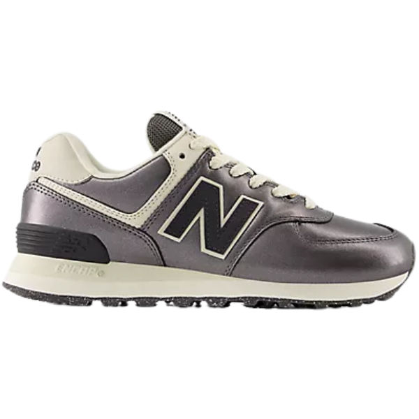 A New Balance Women’s 574 sneaker in bronze/metallic, with a black N logo, shown from the left.