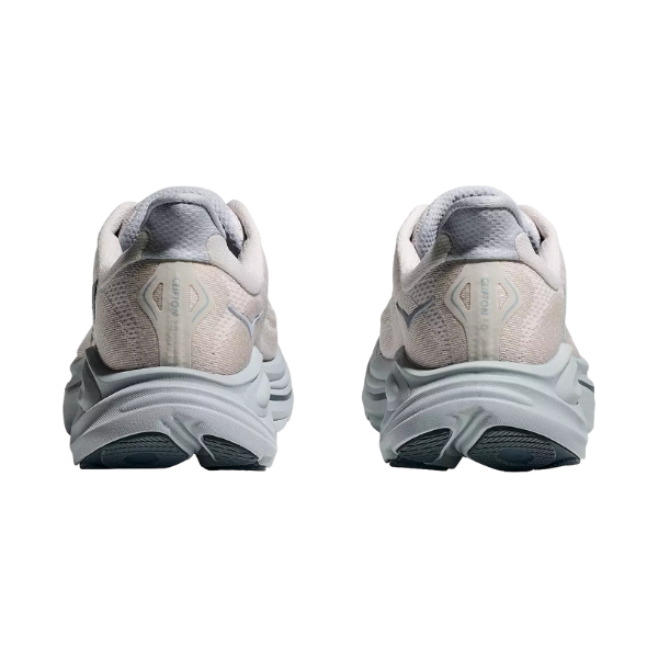 A pair of HOKA Women's Clifton 10 Wide running shoes in Grout/Blue seen from the back on a white background.