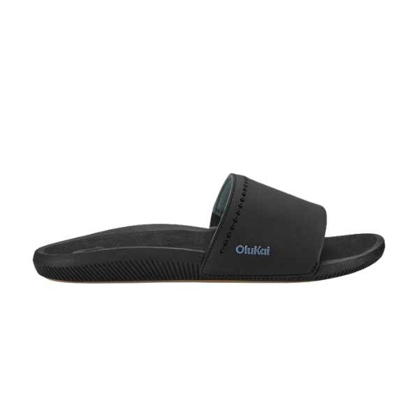 The OLUKAI Women's Ulele Slide Black features a thick strap, supportive footbed, and flat, water-ready sole.