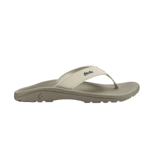 The OLUKAI Women's Ohana Tapa sandal in beige has a textured sole and thin strap—perfect comfort for any occasion.