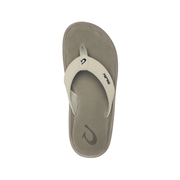 OLUKAI Women's Ohana Tapa sandals—beige, water-resistant, comfy beach footwear with a grey sole and logo.