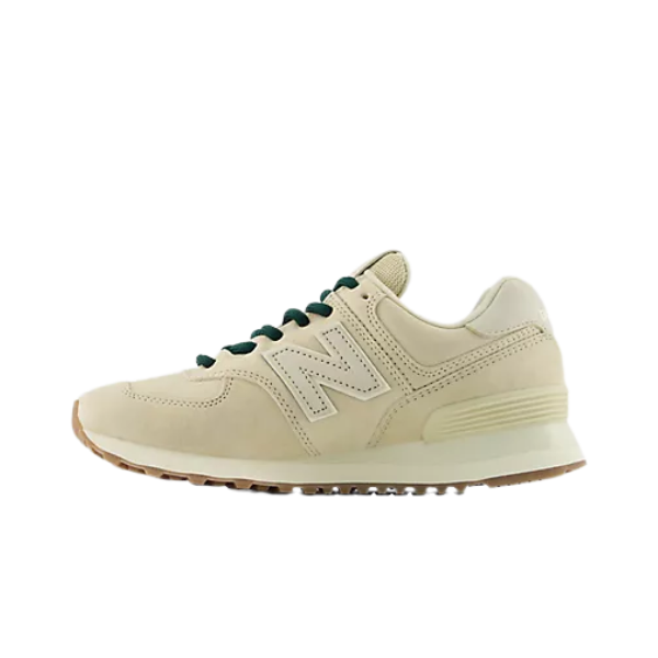 New Balance Women's 574 Tan sneakers with black laces, white sole, and bold N logo, viewed from the left.
