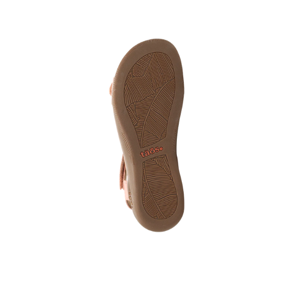 Bottom view of the Taos Women's The Show Blush Pink sandal showing its sole, arch support, and TAOS logo in orange.