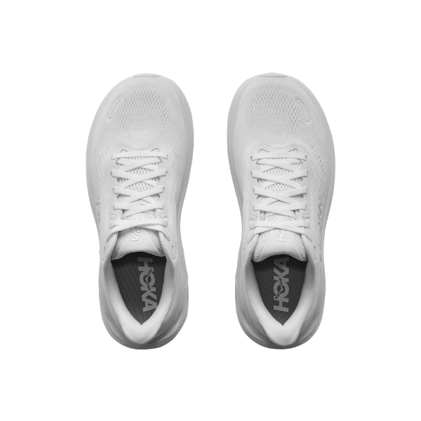 Top view of HOKA Women's Clifton 11 Wide White/White sneakers with visible laces and dark insoles on white.