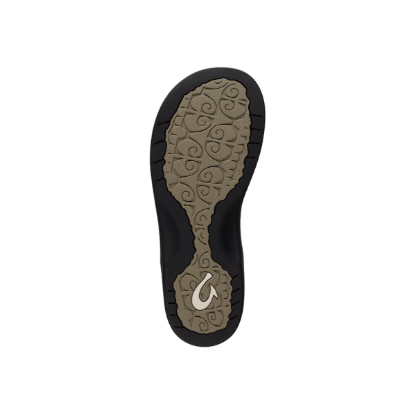 The OLUKAI Women’s Ohana Wwarm Taupe sandal has a tan and black sole with a swirling pattern design.