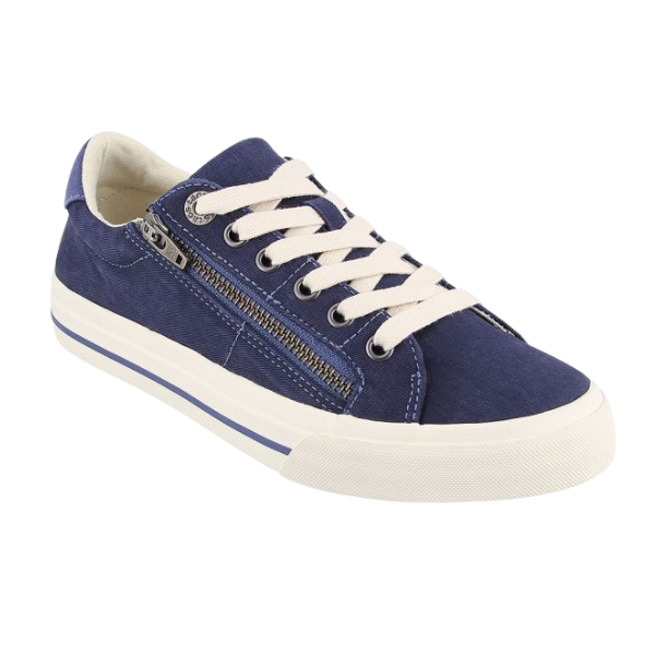 The TAOS Taos Womens Z Soul Navy/Indigo Distressed sneaker features navy blue canvas, white laces, a white rubber sole with blue stripe, a side zipper, arch support, and removable footbed. Image shows the shoe’s outer side and front angle.