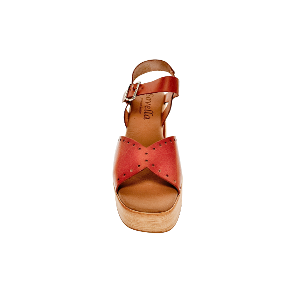 The SOVELLA Womens Lucia Tan sandal features a tan leather upper, wooden platform heel, supportive footbed, ankle strap, and open toe. Shown from the front against a white background.