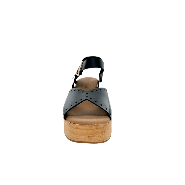 Front view of the SOVELLA Womens Lucia Black sandal, featuring a wooden platform sole, brown footbed, black leather crisscross straps with perforations, and an ankle buckle—stylish support and foot pain relief by SOVELLA.