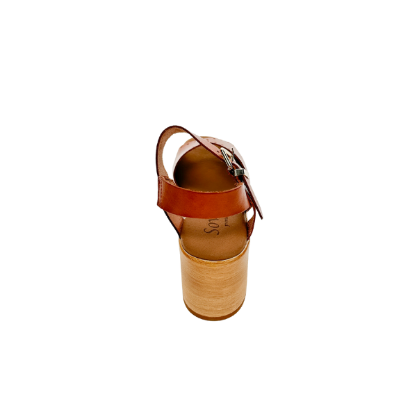 The SOVELLA Womens Lucia Tan is a brown leather sandal with an ankle strap, thick wooden platform heel, and supportive footbed, shown from the back on a white background.