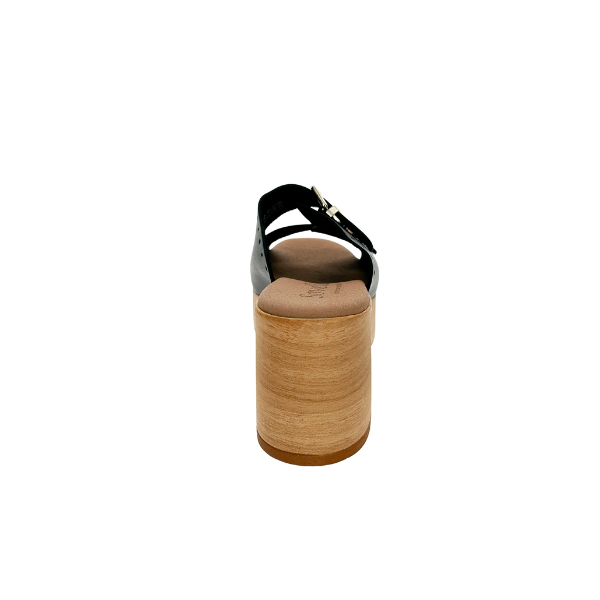 A rear view of the Sovella Womens Paola Black sandal by SOVELLA, featuring a wooden platform, black strap, and gold buckle on a white background—ideal for all-day comfort with supportive heels.
