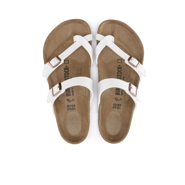 A pair of BIRKENSTOCK Womens Mayari Birko-Flor White Leather sandals with metal buckles and an anatomically shaped footbed, shown from above on a white background.