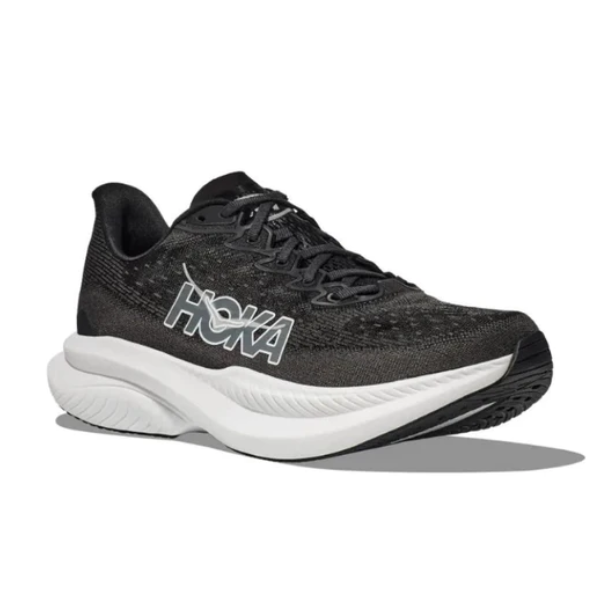 The HOKA Mens Mach 6 (Wide Width) in Black/White features a thick cushioned sole and bold logo, designed for everyday running, and is shown on a plain white background.