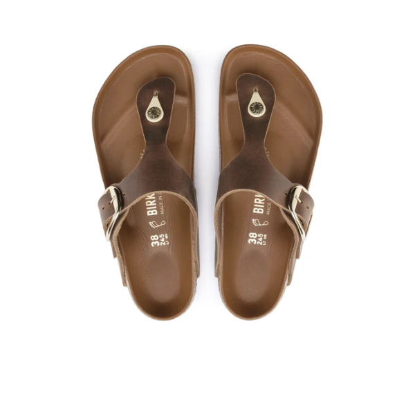 A pair of BIRKENSTOCK Womens Gizeh Big Buckle Oiled Leather Cognac thong sandals with adjustable straps and toe loops, viewed from above on a white background.