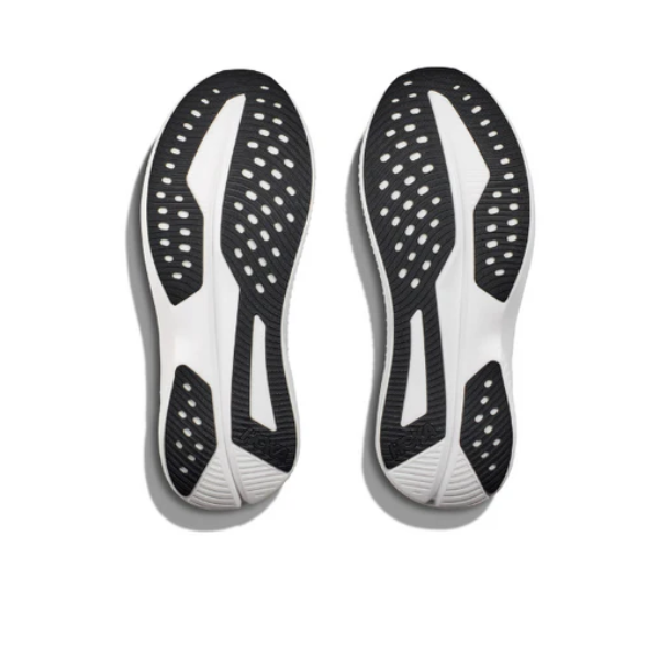 A pair of HOKA Mens Mach 6 (Wide Width) Black/White shoes shown from below, with black and white rubber soles featuring oval cutouts and textured tread—perfect for daily runs or speed workouts.