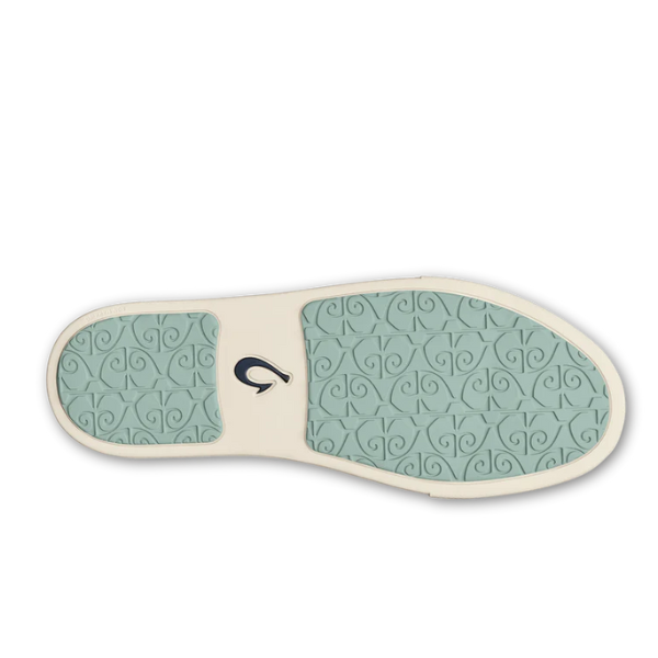 The OLUKAI Womens Pehuea Li Sneakers in off-white feature light teal rubber soles with a swirl pattern and embossed wave logo, surrounded by an off-white border. Breathable mesh ensures all-day comfort.