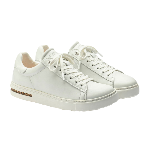 The Birkenstock Mens Bend Low White by BIRKENSTOCK features white natural leather, white laces, and a gold accent on the heel, shown against a plain white background.