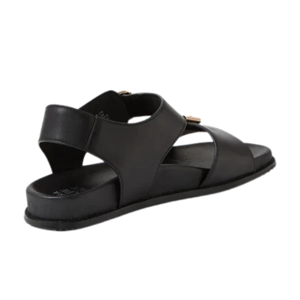 The ZIERA Womens Hastice Black Leather sandal features Wide crisscross straps, a flat sole, and supportive back strap for comfort and pain relief. Shown in a three-quarter rear view on a white background.