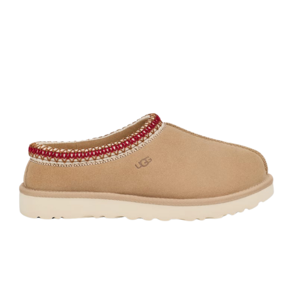 The UGG Womens Tasman Slipper Sand/Dark Cherry features tan suede, cozy wool lining, a cream sole, red-and-white ankle trim, and the signature UGG logo—capturing the classic style of this beloved slip-on clog.